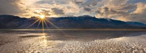 Sunlight beams through a break in the clouds onto a lake over Steens Mountain.
